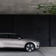 A photo of a golden Polestar 2 electric sedan parked in a garage.